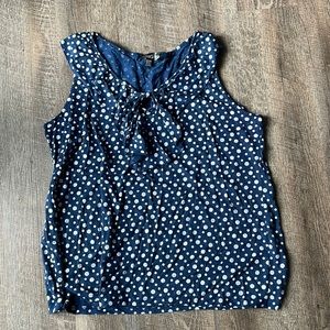 Navy polka dot tank with fabric “ruffle” around neck line